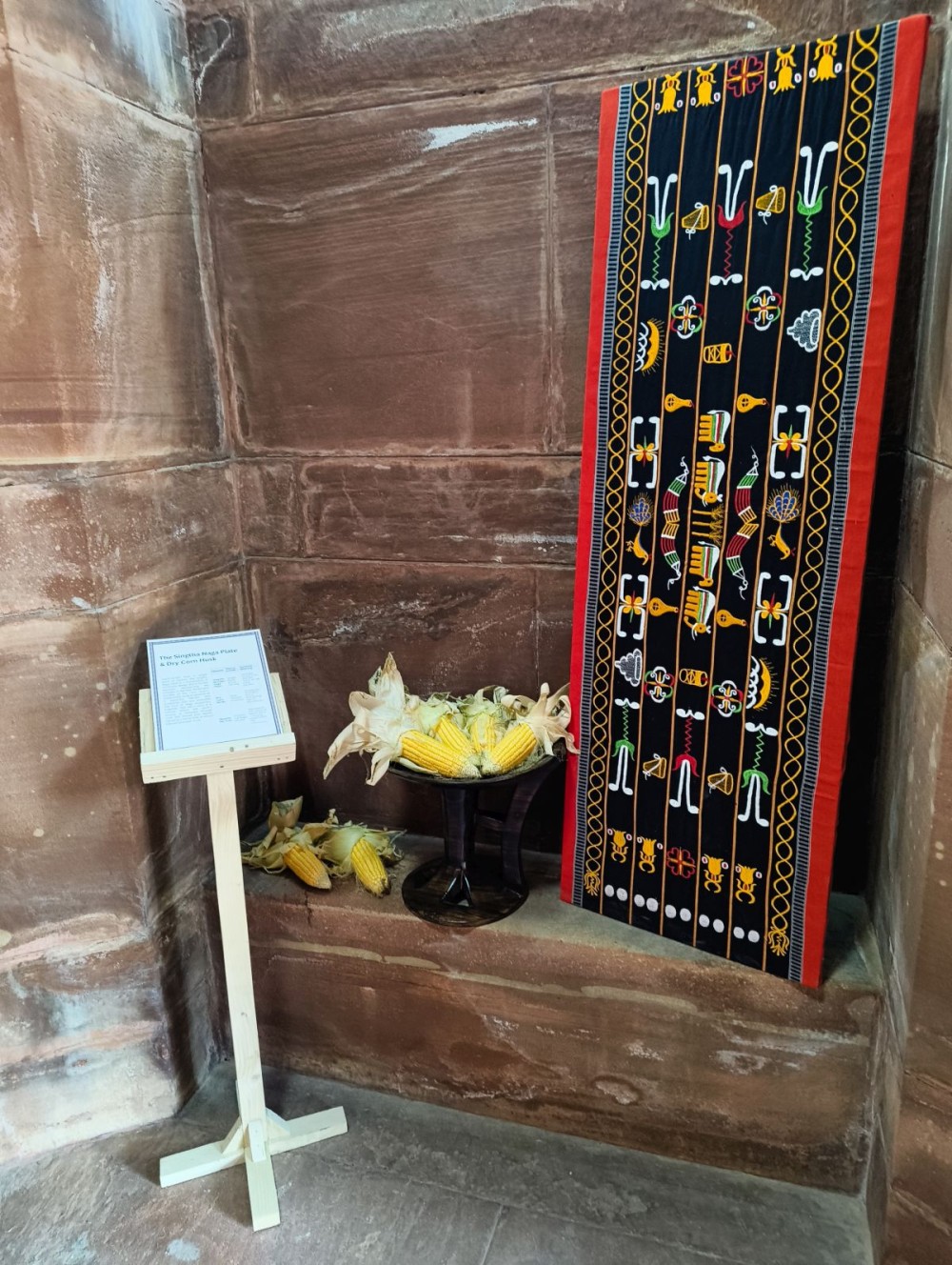 Singtha Naga plate and bundles of dry corn husks displayed at the President’s “At Home” reception at Rashtrapati Bhavan on Republic Day, January 26, symbolising the warmth and bounty of the Naga kitchen. They are paired with a Naga shawl. (Photo Courtesy: NEHHDC)